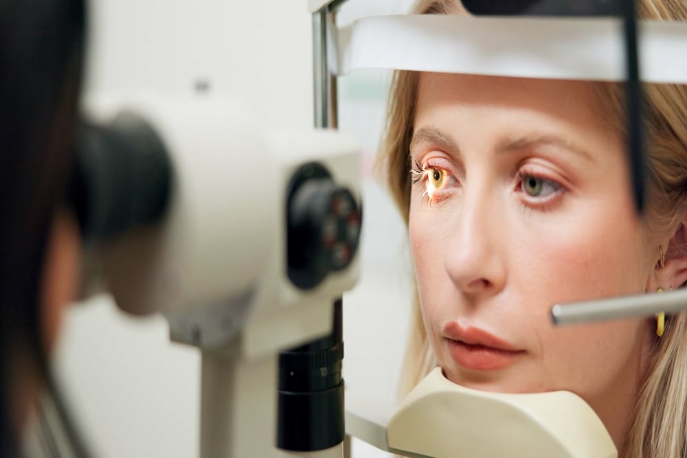 Woman having a comprehensive eye exam to help diagnosis any dangerous eye conditions ahead of time